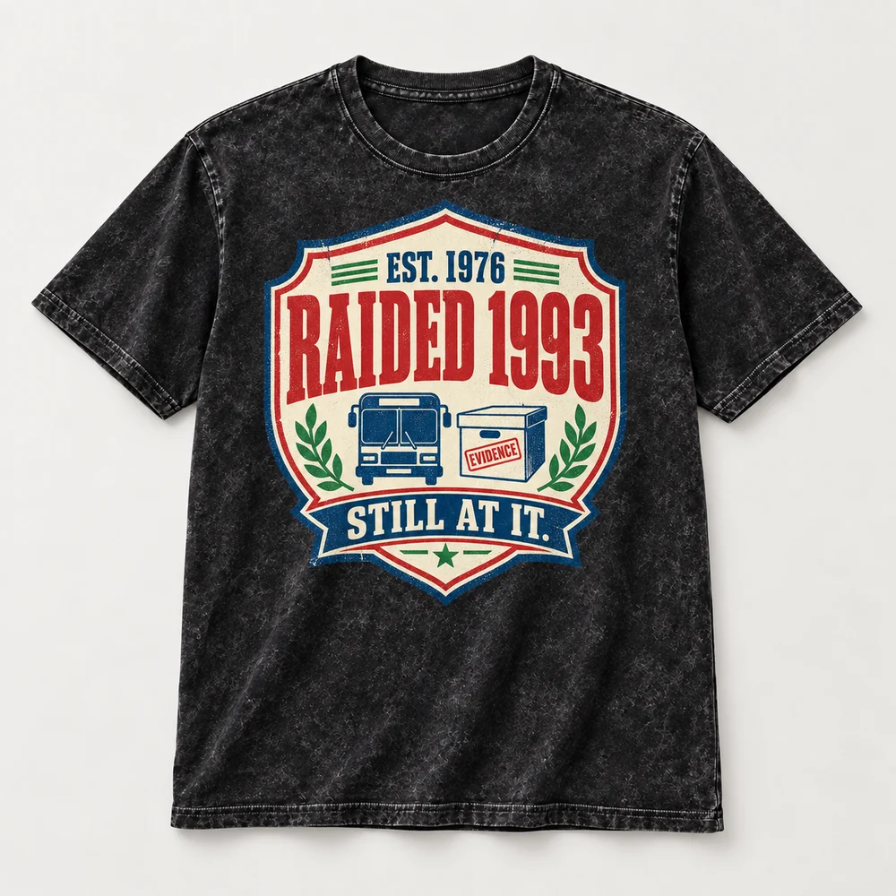 Est. 1976. Raided 1993. Still At It. tee, flat